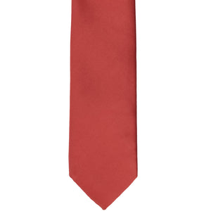 Front bottom view of a persimmon colored tie in a slim width