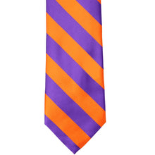Load image into Gallery viewer, The front of an orange and purple striped tie, laid out flat
