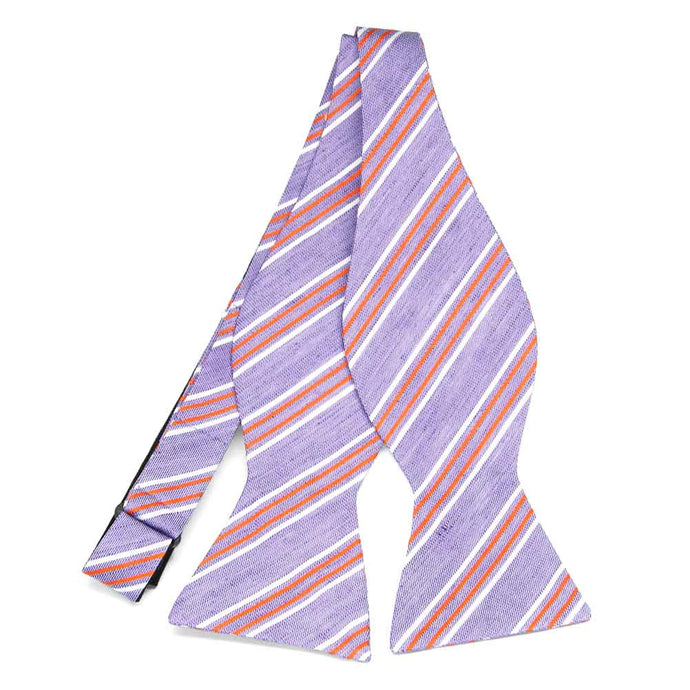 An untied light purple self-tie bow tie with orange and white stripes