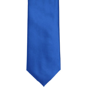 The front of a royal blue solid tie, laid out flat