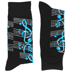 A folded pair of black men's socks with sheet music running across