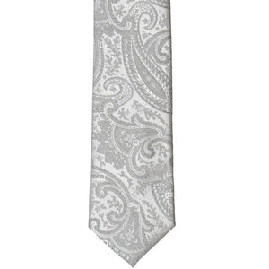 The front bottom of a silver paisley tie