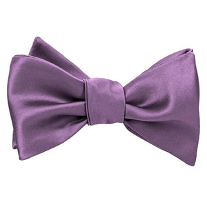 A solid wisteria purple self-tie bow tie, tied