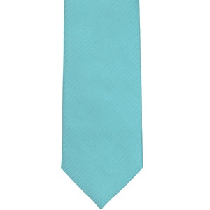 The front of a turquoise herringbone tie, laid out flat