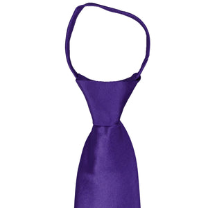 The front of the knot and collar on an amethyst purple zipper tie