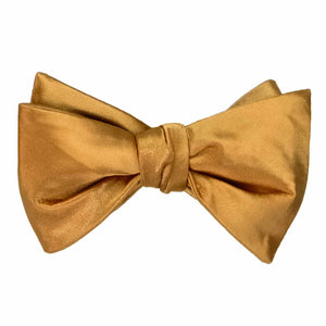 Solid color antique gold self-tie bow tie, tied