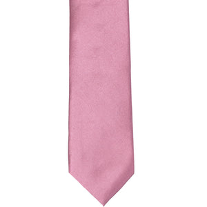 The front of an antique pink slim tie, laid out flat