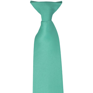 The pre-tied knot on an aquamarine clip-on tie