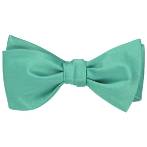 Solid color aquamarine self-tie bow tie, tied