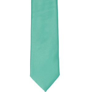 The front of an aquamarine slim tie, laid out flat
