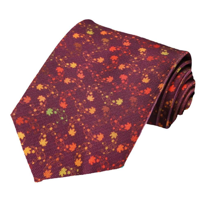 A burgundy extra long tie with a falling leaves pattern
