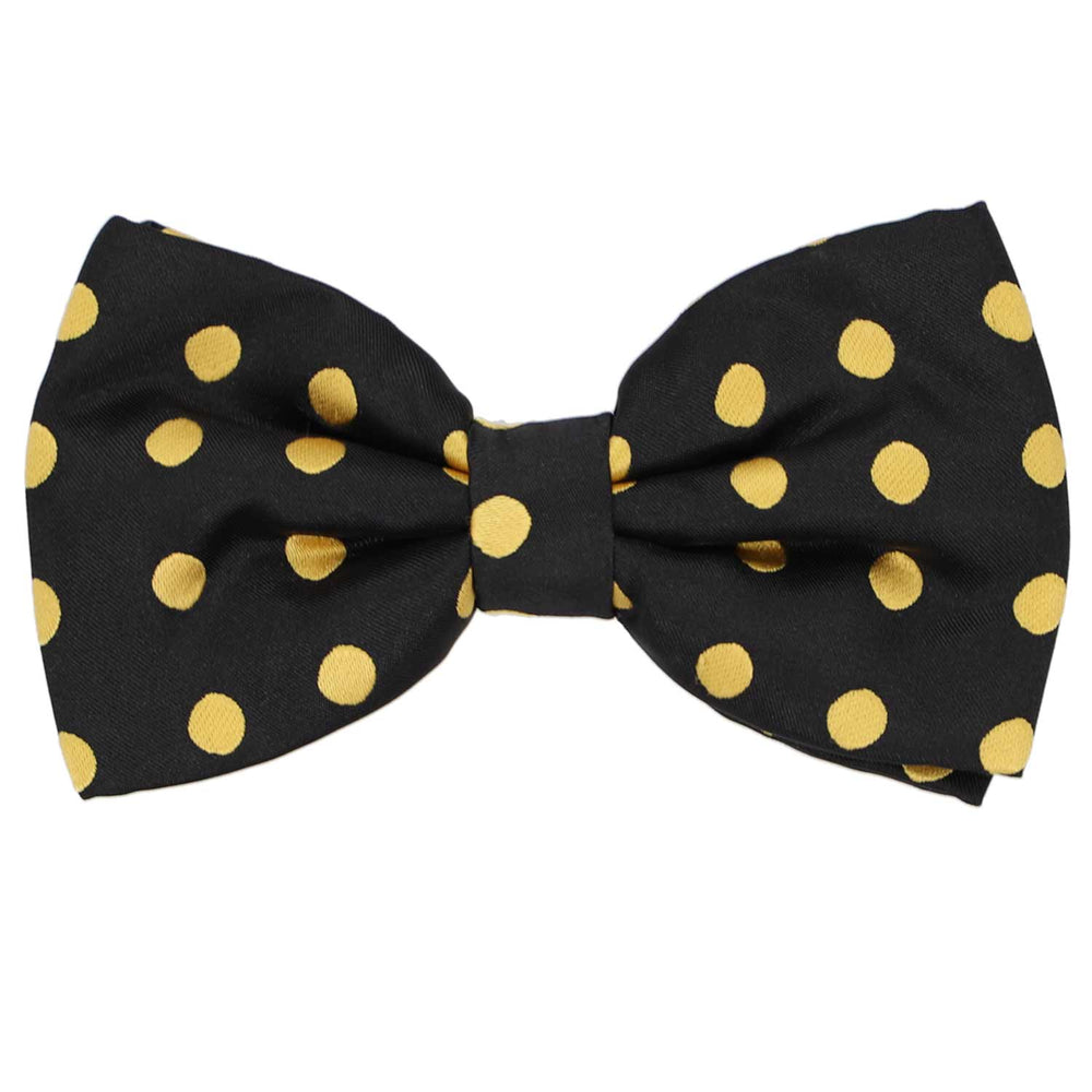 A black pre-tied bow tie with gold polka dots in a medium size