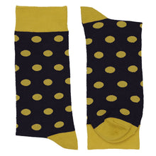 Load image into Gallery viewer, A folded pair of black dress socks with gold polka dots, a gold cuff, toe, and heel, displayed flat against a white background.