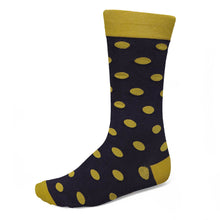 Load image into Gallery viewer, A single crew sock with a black base and gold polka dots, featuring a solid gold cuff, heel, and toe, shown on a plain white background.
