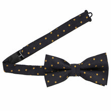 Load image into Gallery viewer, A black bow tie with gold polka dots, pre-tied with the band collar open