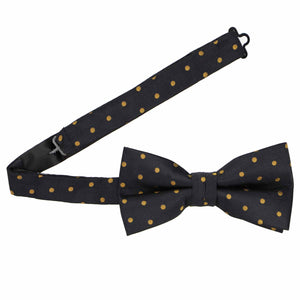 A black bow tie with gold polka dots, pre-tied with the band collar open