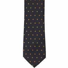 Load image into Gallery viewer, The front of a black and old gold polka dot necktie, laid out flat
