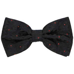 A pre-tied textured black bow tie with red metallic polka dots