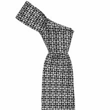 Load image into Gallery viewer, Tied knot on a black and white medallion pattern necktie