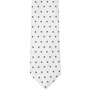 The front of a white and black polka dot necktie