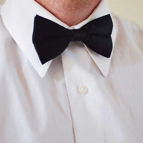Black bow tie worn with a white dress shirt