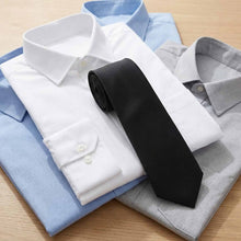 Load image into Gallery viewer, Folded shirts and a black tie on a wooden surface
