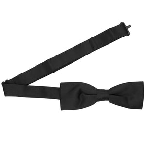A black pre-tied slim bow tie with the band collar open