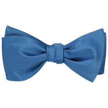 Load image into Gallery viewer, A solid blue self-tie bow tie, tied