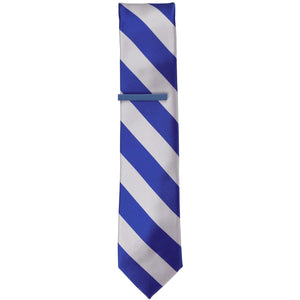 A solid blue tie bar on a royal blue and silver striped slim tie