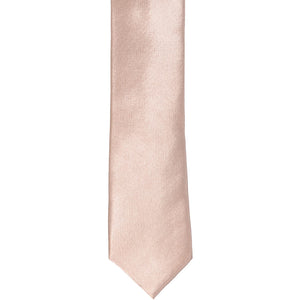 The front of a blush pink skinny tie, laid flat