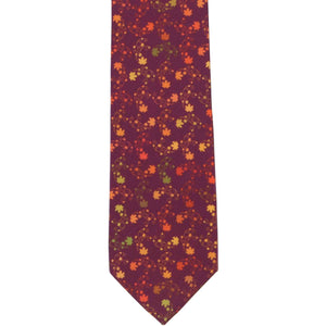The front of a burgundy boys' tie with a leaf pattern