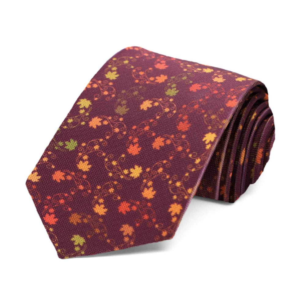 A boys' burgundy tie with a swirling pattern of leaves