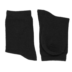 A folded pair of boys black socks