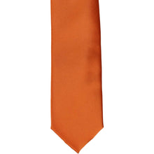 Load image into Gallery viewer, The front of a boys&#39; burnt orange solid tie, laid out flat