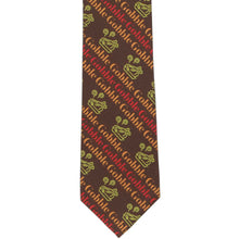 Load image into Gallery viewer, The front of a boys&#39; Thanksgiving brown tie with a striped gobble and cooked turkey design