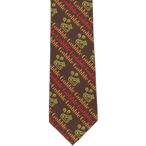 The front of a boys' Thanksgiving brown tie with a striped gobble and cooked turkey design