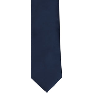 The front of a boys' navy blue solid tie, laid flat