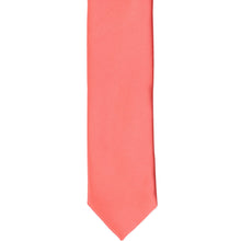 Load image into Gallery viewer, The front of a bright coral skinny tie, laid flat