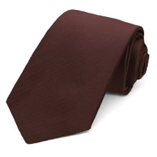 Load image into Gallery viewer, A rolled-up men's necktie in a brown color, featuring a subtle herringbone pattern, set against a plain white background.