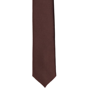 The front of a brown skinny tie, laid flat