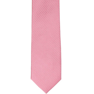 The front of a bubblegum pink tone on tone herringbone slim tie, laid flat
