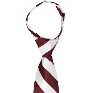 The knot on a burgundy and white striped zipper tie