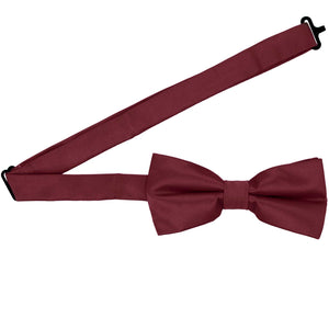 A burgundy bow tie with the band collar open