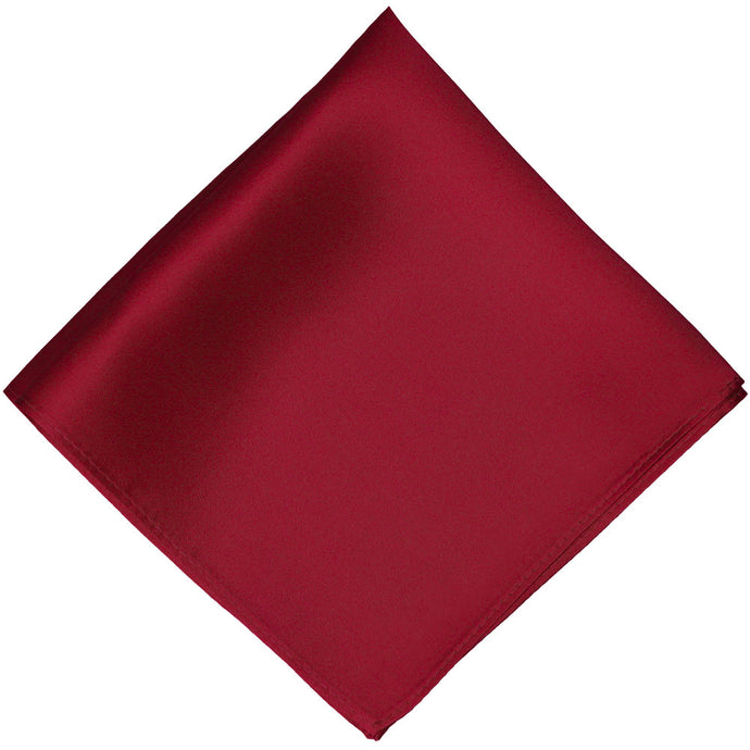 A burgundy silk pocket square, folded into a diamond shape