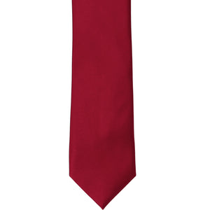 The front of a burgundy silk slim tie, laid out flat