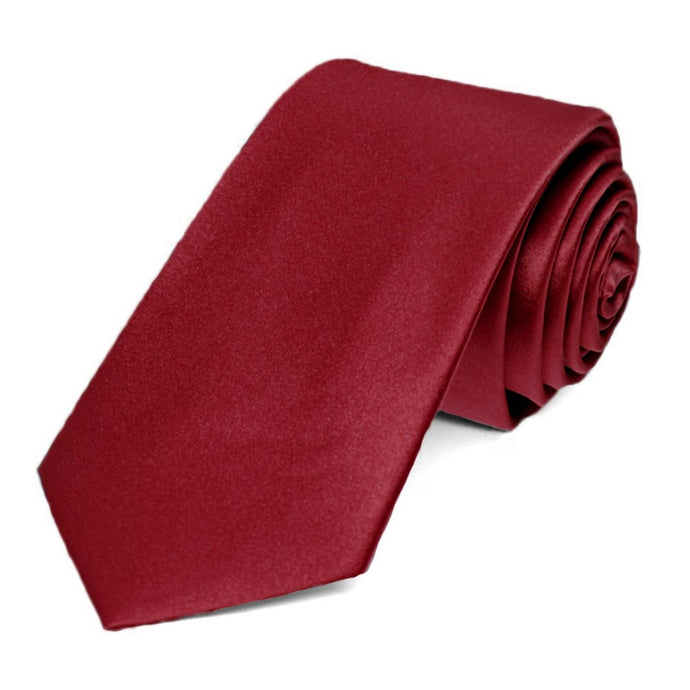 A solid burgundy slim tie made from silk