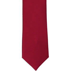 The front of a burgundy solid silk tie, laid flat