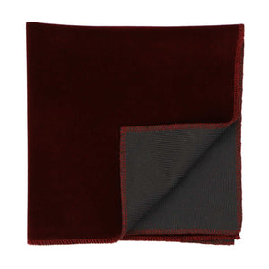 A burgundy velvet pocket square with a corner folded flipped up to show the back