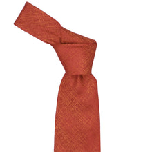 Load image into Gallery viewer, A textured burnt orange necktie with a subtle diagonal woven pattern, tied in a standard knot and presented on a solid white background.