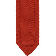 Load image into Gallery viewer, Back of a burnt orange knit tie showing the tie tail